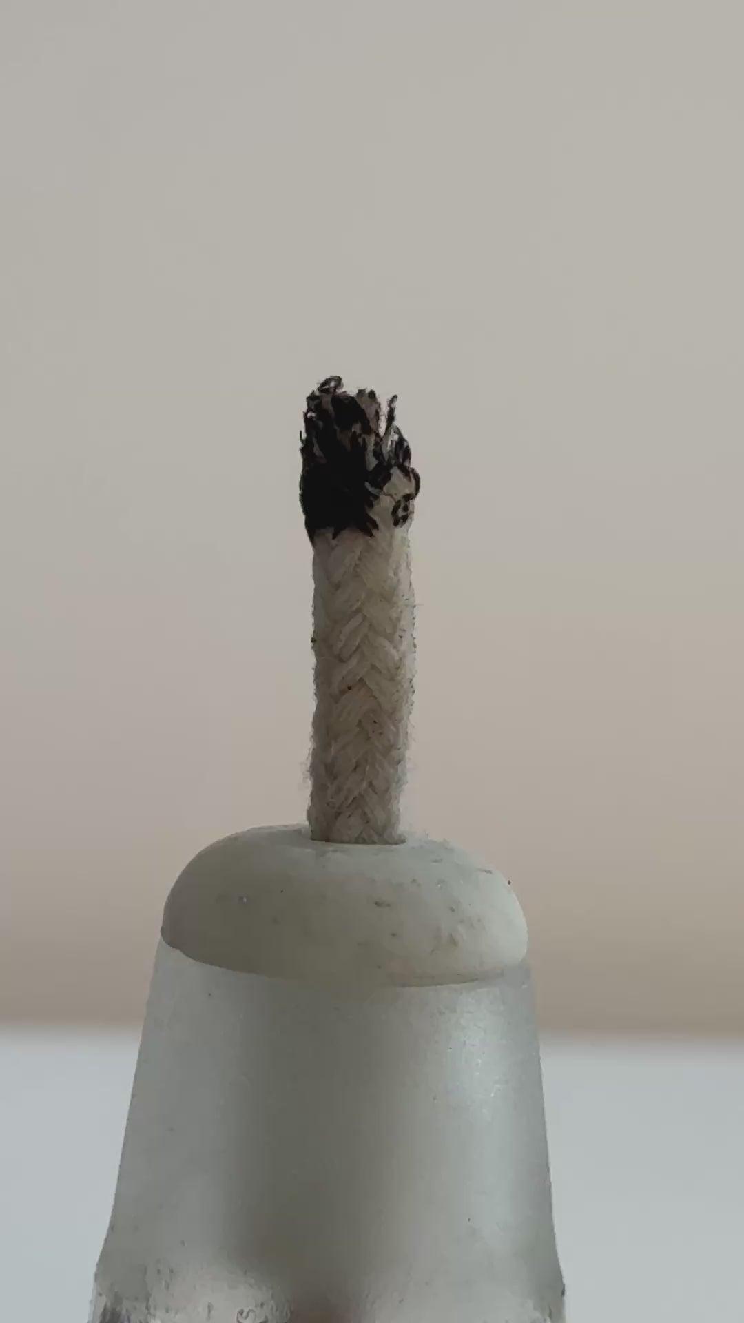 A short video showcasing the jewelry making process, including a close-up of a lit alcohol lamp wick, a jeweler carving a wax ring model on a workbench, and the final polishing and detailing of a finished metal ring using a rotary tool.